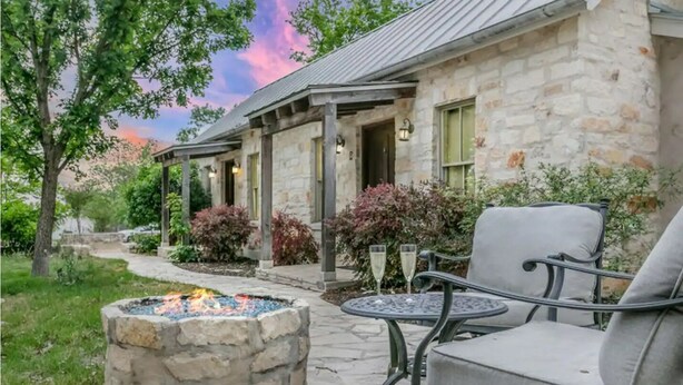 A stone building with a fire pit and outdoor seating. - Stonebridge 2: 2 Blocks to Main, Shared Hot Tub (Fredericksburg)
