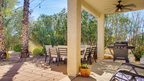 An outdoor patio with a covered seating area, a grill, and string lights. - Pet-friendly Snowbird Haven w/ Pool in Gold Canyon (Gold Canyon)