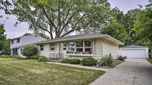A single-story house with a front porch, a garage, and a well-maintained lawn.