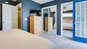 A bedroom with a bed, a dresser, a TV, and a closet with a mirror. - Bay-view Retreat w/ 5 Balconies in Bethany Beach! (Bethany Beach)