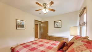 A bedroom with a bed, a ceiling fan, a dresser, and two framed pictures on the wall. - Fish, Hike, Hunt: Secluded Cabin in Doe Hill! (Doe Hill)