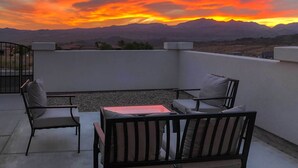 A rooftop terrace with a view of mountains during sunset. - Luxe Home w/ OHV Access, 5 Mi to Lake Mohave! (Bullhead City)