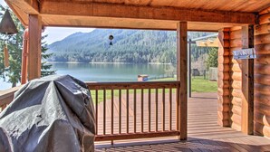 A wooden deck with a view of a lake and mountains. - Lakefront Eatonville Cabin w/ Dock & Mtn Views! (Eatonville)