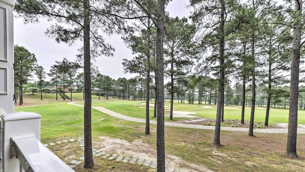 A view of a golf course with tall pine trees and a well-maintained lawn. - Anderson Creek Club Condo w/ Community Amenities! (Spring Lake)