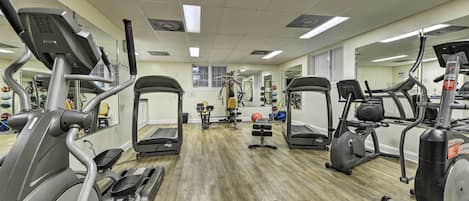 A gym with treadmills, elliptical machines, and weight equipment.