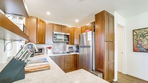 A modern kitchen with wooden cabinets, stainless steel appliances, and a marble countertop. - Walk to Trails! Sedona Casita w/ Fire Pit & Views (Sedona)
