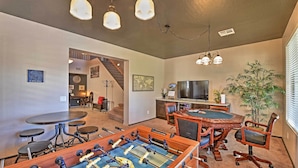 A room with a foosball table, a desk with a computer, and a large window with blinds. - Arizona Retreat w/ Heated Pool, Fire Pit & Grill! (Surprise)