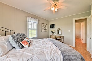 A bedroom with a bed, a ceiling fan, a dresser, and a television. - Peaceful Elkin Vacation Rental ~ 17 Mi to Mt Airy! (Elkin)