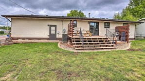 A single-story mobile home with a front porch, a small deck, and a front yard. - Rapid City Home - Walk to Canyon Lake Park (Rapid City)
