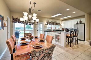 Enjoy meal preparation and dining in this well-equipped kitchen with a large island, sink, and ample counter space.