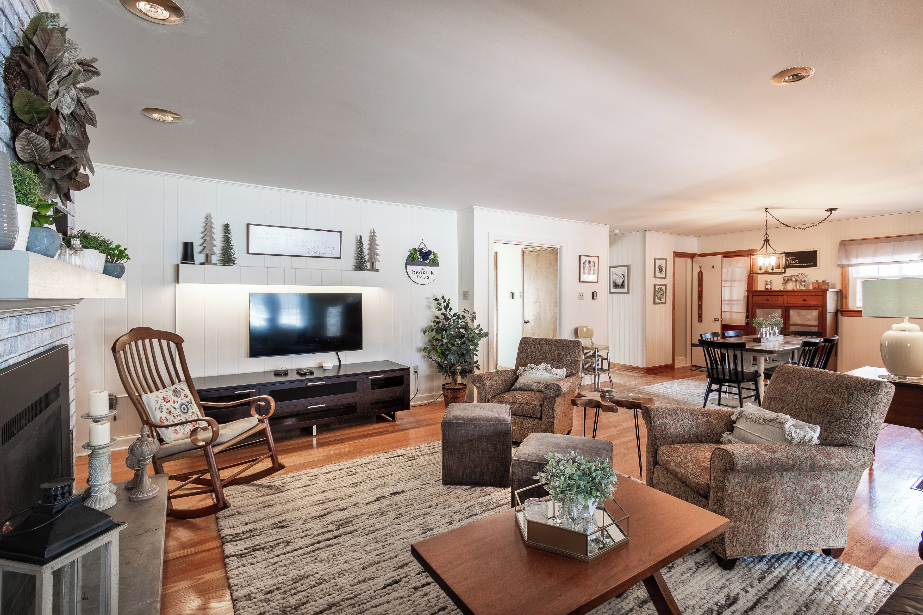 A living room with a fireplace, television, and seating area.