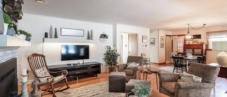 A living room with a fireplace, television, and seating area.