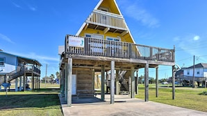 A yellow building with a balcony and a sign that reads "CAPE JOY". - 2 Blocks to Surfside Beach: A-frame Home w/ Deck (Freeport)