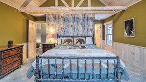 A bedroom with a wooden ceiling, a bed with a quilt, a dresser, and a window. - 2 Mi to Schuss Mtn! Northern Retreat w/ Game Room (Bellaire)