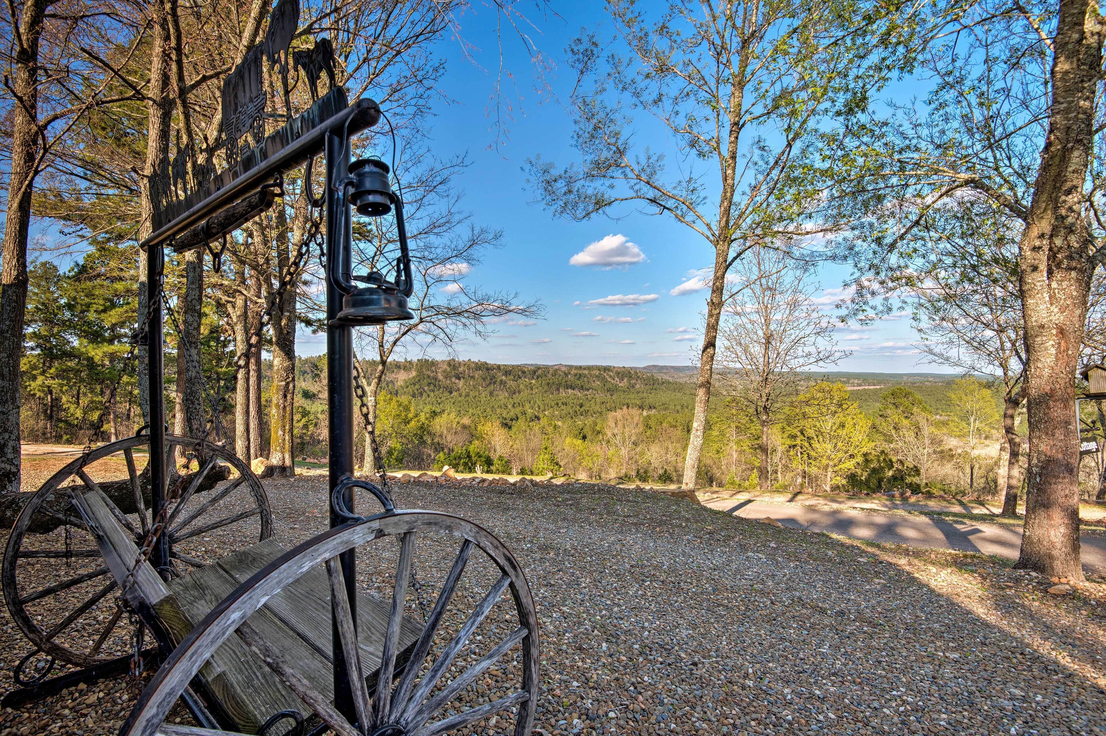 A rustic outdoor setting with a wooden cart and a vintage lantern, surrounded by trees and a clear sky.