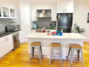 Enjoy cooking in this well-equipped kitchen with a central island and appliances.
