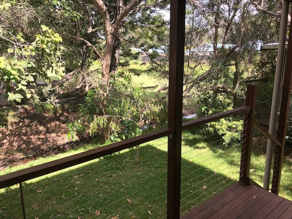 Enjoy a serene view of the lush garden from this elevated deck.