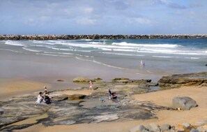 Guests can enjoy a scenic beach experience with calm waters and a protected shoreline.