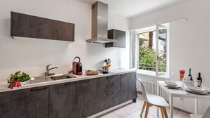 A modern kitchen with a large island, built-in appliances, and a view to the outdoors. - Serenata 5 - Cavigliano Studios with Terrace for 4, Cavigliano, Centovalli, Switzerland (Cavigliano, Centovalli)