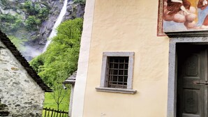 A building with a stone facade, a small window, and a door. - Serenata Room 2 - Cavigliano Studio with Terrace for 3, Cavigliano, Centovalli, Switzerland (Cavigliano, Centovalli)