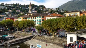 A coastal town with a prominent church, a marina, and a crowd gathered near a white building with a sign reading "ASCONA". - Serenata Room 2 - Cavigliano Studio with Terrace for 3, Cavigliano, Centovalli, Switzerland (Cavigliano, Centovalli)