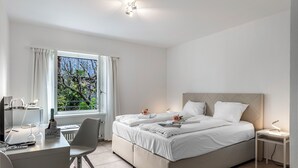 A modern bedroom with a bed, a desk, and a window with curtains. - Serenata Room 2 - Cavigliano Studio with Terrace for 3, Cavigliano, Centovalli, Switzerland (Cavigliano, Centovalli)
