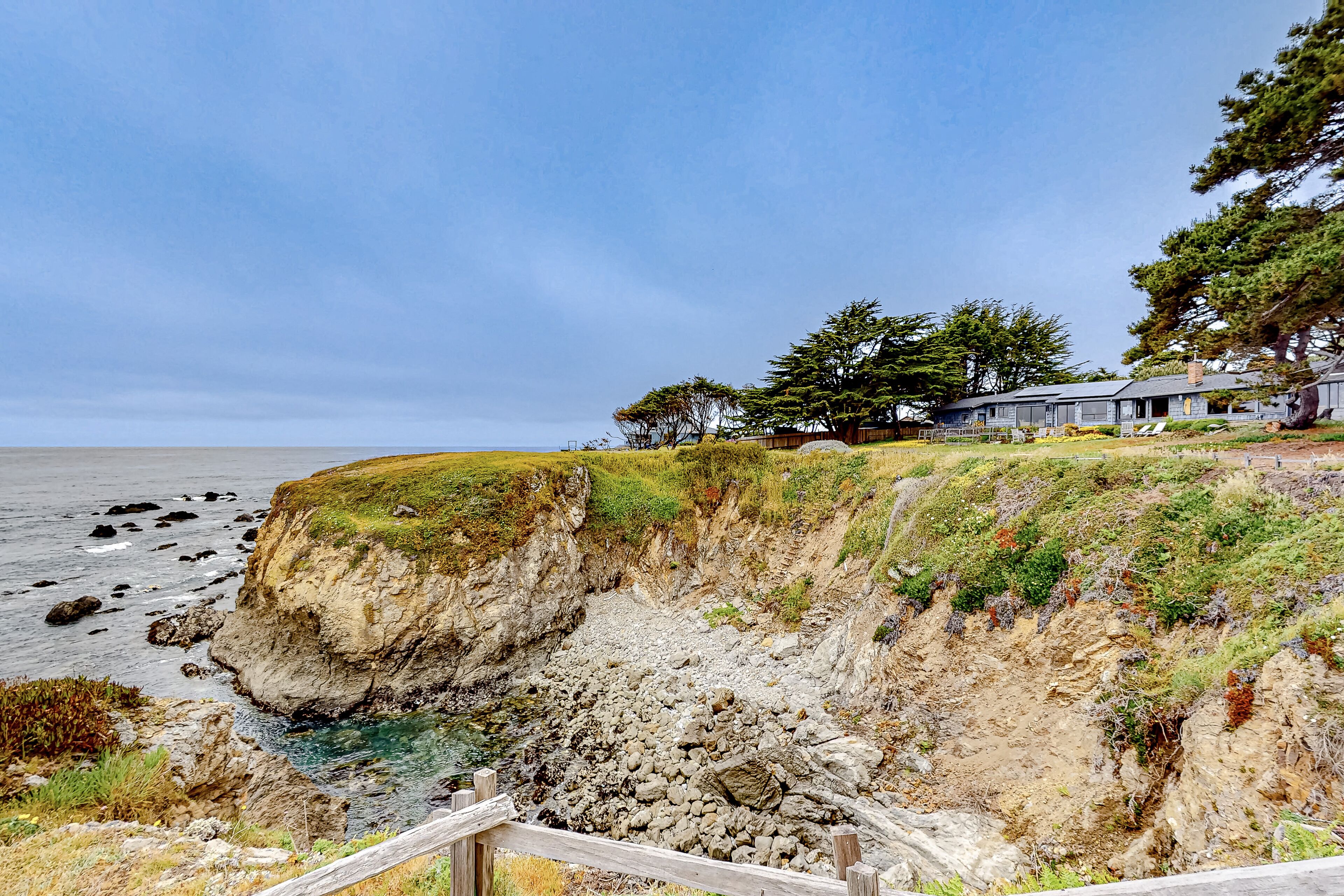Oceanfront home steps to the beach with impressive ocean & cove views & deck