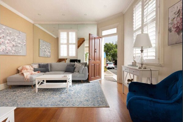 Relax in this inviting living space with a sofa, coffee table, and armchair.