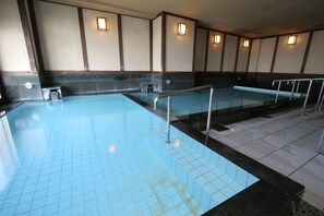 A swimming pool with tiled flooring and metal railings. - HOTEL GRANDSPA AVENUE (Asakura)