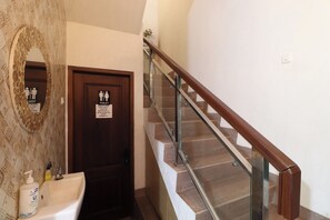 A bathroom with a sink, hand sanitizer, and a toilet sign. - Bisma Balcony Homestay (Pogung Lor)