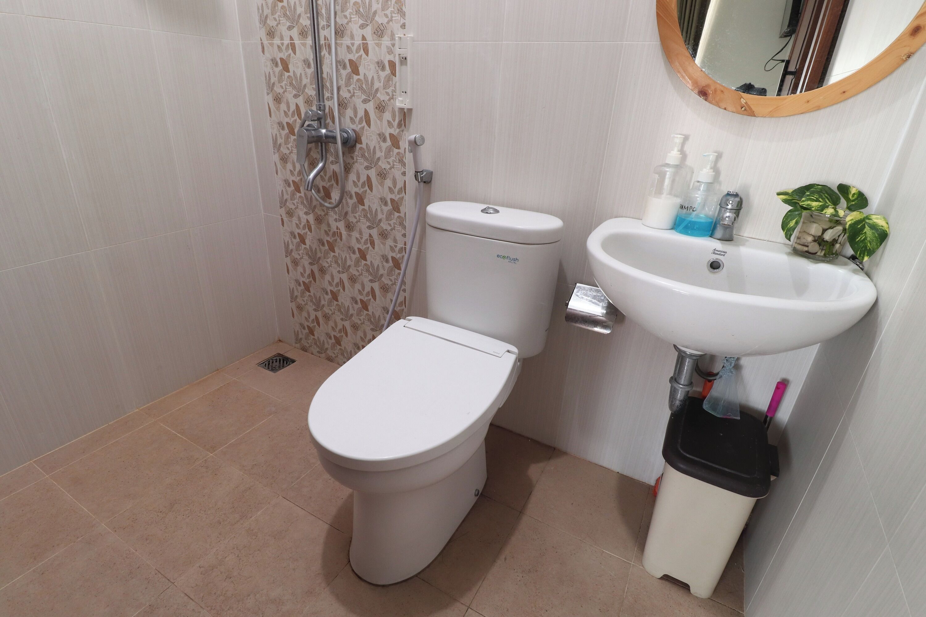 A bathroom with a toilet, a sink, and a shower.