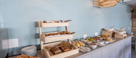 A buffet setup with various food items and wooden serving trays.