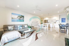 Executive Condo | Living area | 60-inch Smart TV with cable channels, TV, Netflix - ZEN At ARRAY - 2 Bedroom Retreat in CBD (Darwin)