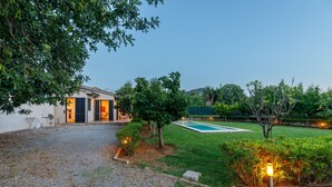 A residential property with a gravel driveway, a swimming pool, and a well-maintained lawn. - Villa 'Alfonsa' with Mountain View, Wi-Fi and Air Conditioning (pollensa)