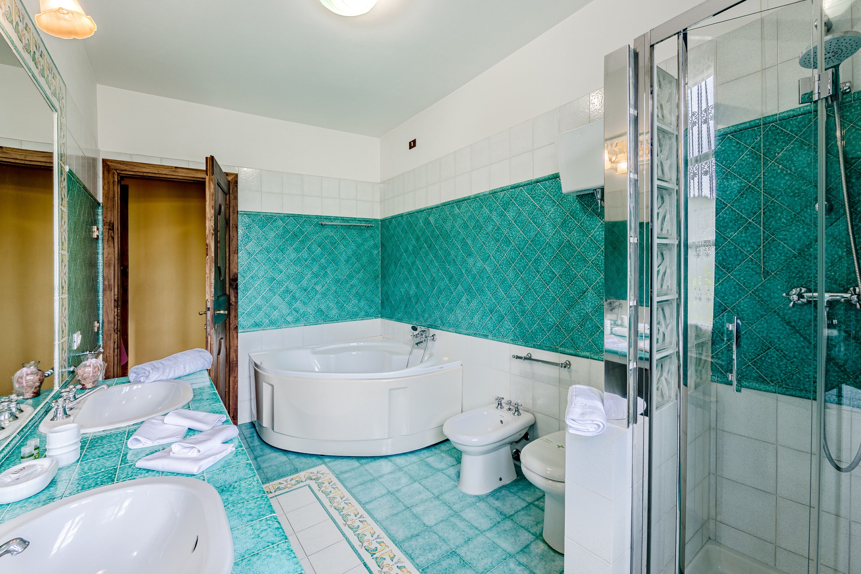 A bathroom with a bathtub, a shower, a toilet, and a sink.