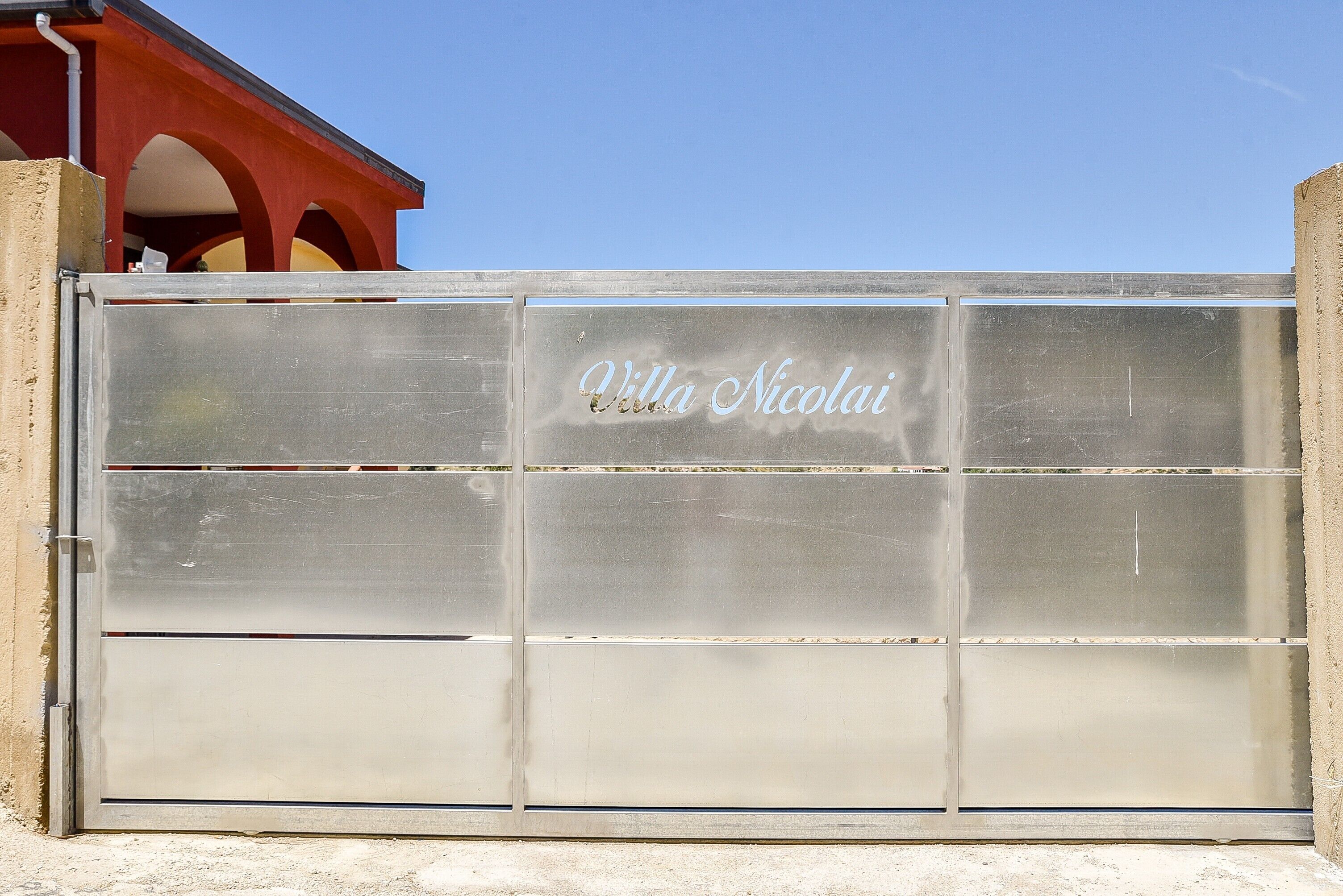 A metal gate with 'Villa Nicolai' engraved on it.