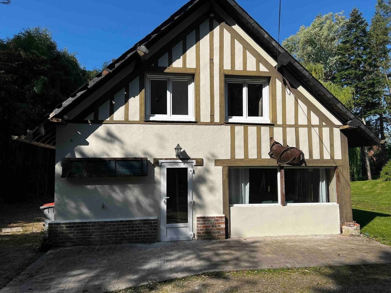 A two-story house with a gabled roof, a front door, and a small porch area.