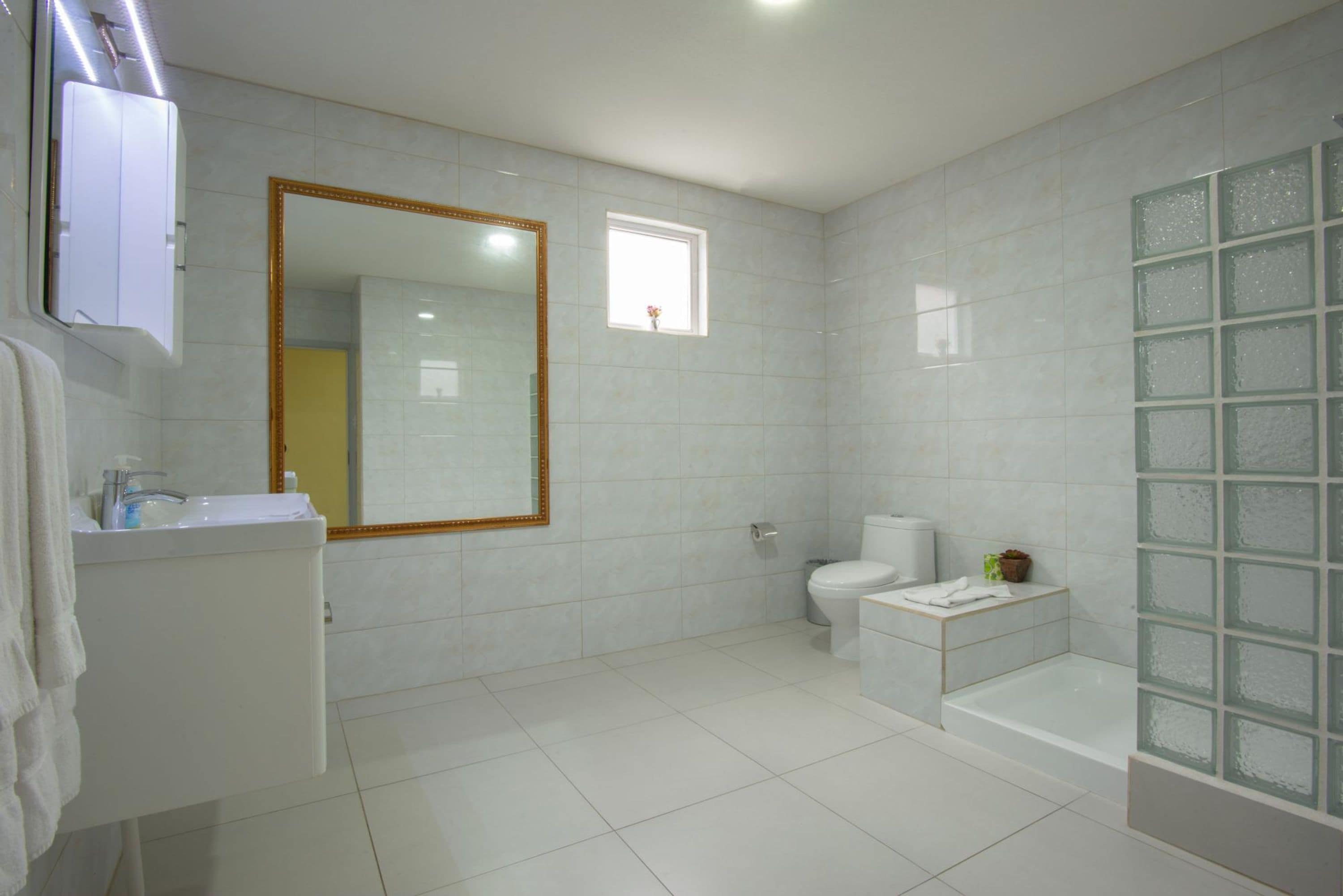 A modern bathroom with a toilet, sink, and bathtub.