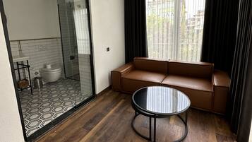 Deluxe Room | Living area | 90-inch LCD TV with satellite channels, TV, heated floors