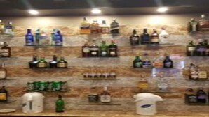 A bar area with shelves of various liquor bottles. - MeroStay 179 Shree (Kathmandu)