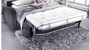 A modern bedroom with a bed, a bedside table, and a lamp. - Modern, Stylish 1 Bedroomed Apartment (Nottingham)