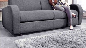 A grey sofa in a modern living room with a grey shag rug. - Modern, Stylish 1 Bedroomed Apartment (Nottingham)