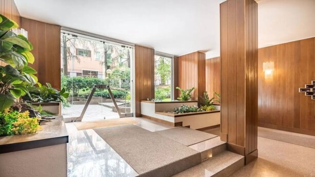 A modern interior with wooden paneling, a staircase, and potted plants. - Apartment in Milan with 4 bedrooms sleeps 7 (Milan)