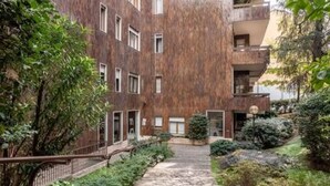 A multi-story building with a brick facade, a stone pathway, and surrounding greenery. - Apartment in Milan with 4 bedrooms sleeps 7 (Milan)