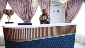 A reception desk with a patterned blue and gold design, a decorative elephant sculpture, and a no-smoking sign on the wall. - Elgibor Best Guest House  (Cape Town)