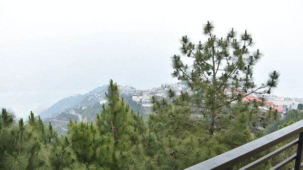 A mountainous landscape with a view of a town in the distance. - Great View Hotel And Restaurant (Tehri)