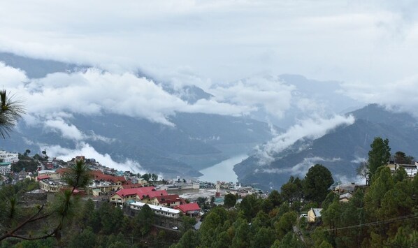 A mountainous landscape with a town nestled in the valley. - Great View Hotel And Restaurant (Tehri)