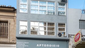 A two-story building with a sign for "Aptoneio" and "Maryflower Premium Apartments." - Executive Apartment With Private Terrace-d (Piraeus)