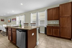 Enjoy cooking in this well-equipped kitchen with a central island and dishwasher.