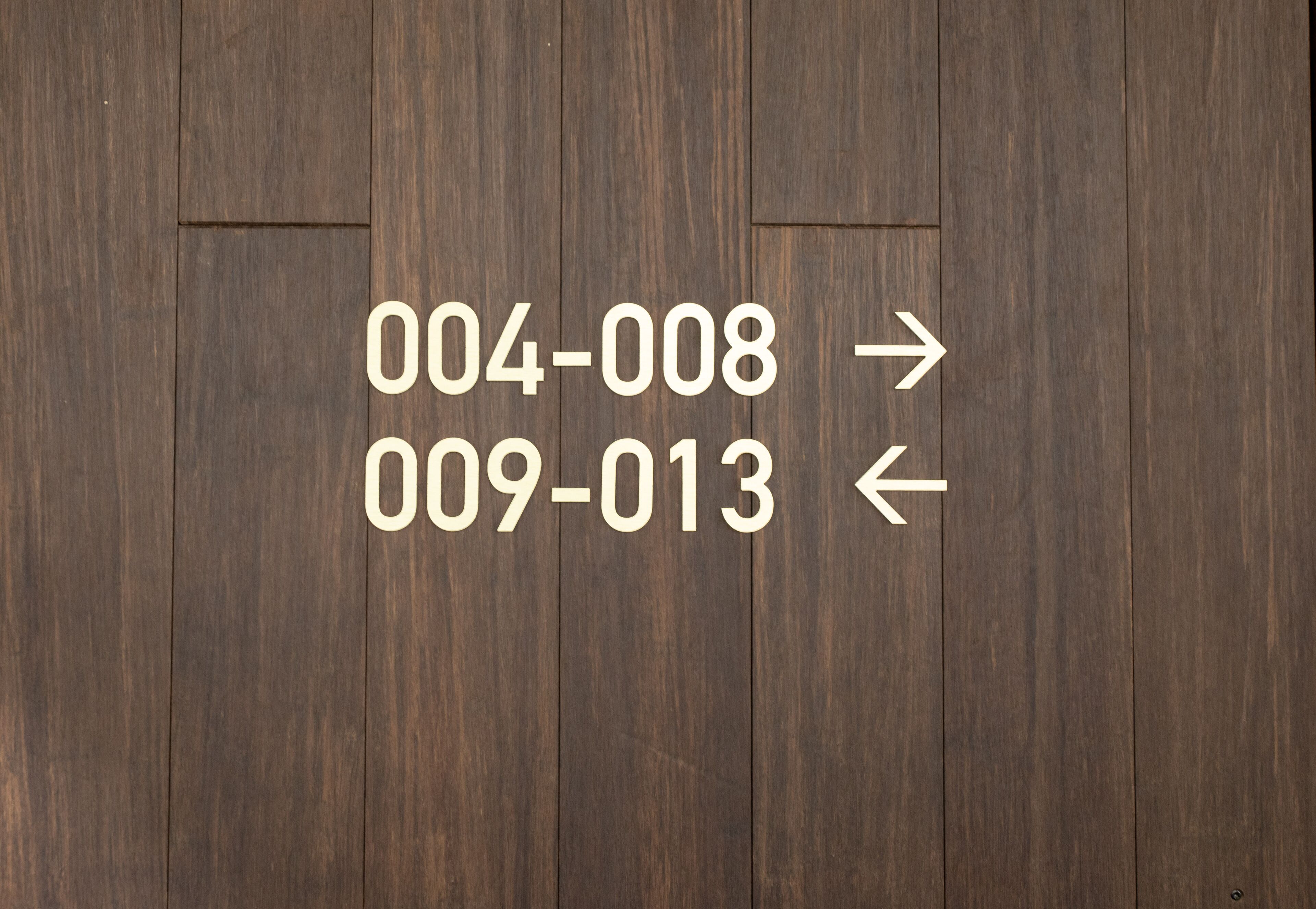 A wooden floor with directional arrows and numbers.